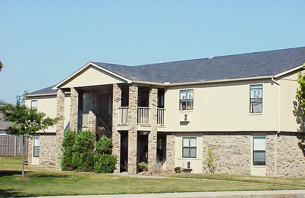 A large two story house with a balcony on the second floor.